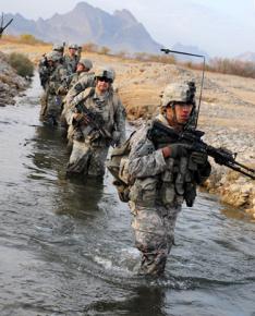 U.S. soldiers cross a stream during a security patrol in Chabar, Afghanistan