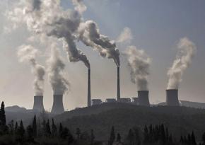 Smokestacks belch pollution at a huge power plant